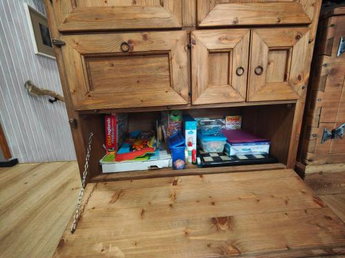 a wooden cabinet with food and toys in it at Alpina Loft in Sauze d'Oulx in Sauze dʼOulx