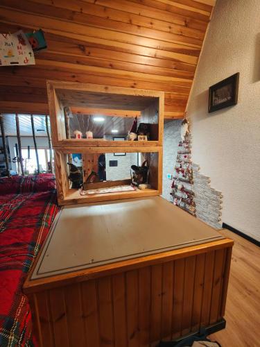 a ping pong table in a room with a christmas tree at Alpina Loft in Sauze d'Oulx in Sauze dʼOulx