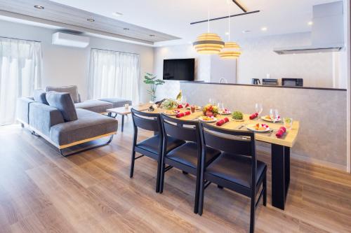a kitchen and living room with a table and chairs at 最大12名OK 駐車3台無料自然豊かな名護エリアの広々一棟貸し Marama Ryukyu 琉球 in Nago