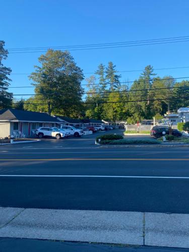 a street with cars parked in a parking lot at Barberry Court Motel &Cabins in Lake George