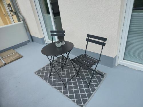 two chairs and a table on a porch at Ferienwohnung Am Brandholz in Altenbeken