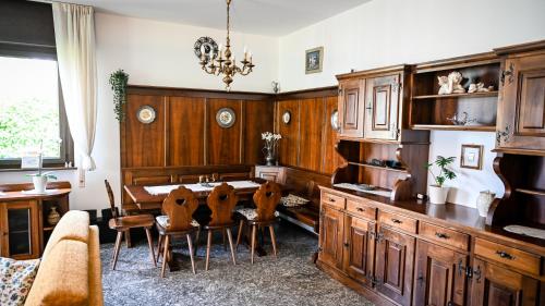 a dining room with a table and chairs at Casa Sala in Castionetto di Chiuro