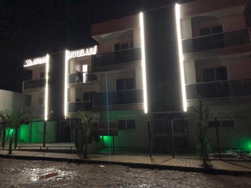 a hotel at night with green lights at IJUÍ APART HOTEl in Ijuí