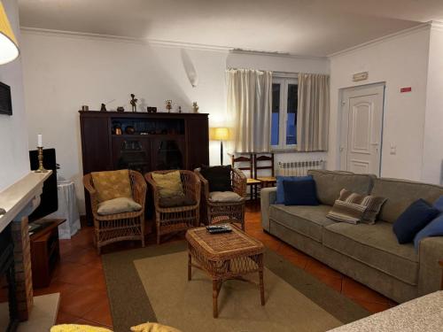 a living room with a couch and chairs at Casa das Oliveiras - Manteigas in Manteigas