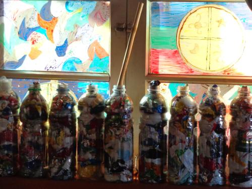 a group of bottles with a clock in the background at Hostal Epu Pewen in Curacautín