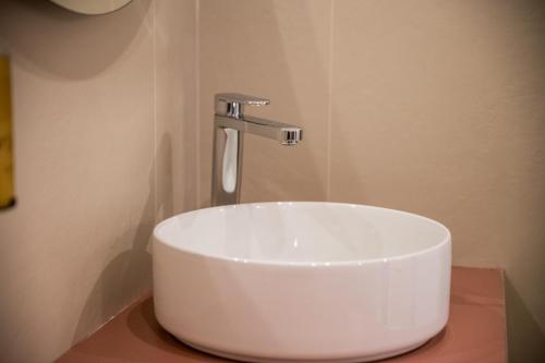 a white sink in a bathroom with a faucet at Show MI Rooms Milano - San Siro Stadio - Ippodromo - Rho Fiera in Milan