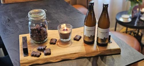 two bottles of champagne and a candle on a table at Apartament Przy Murach in Toruń