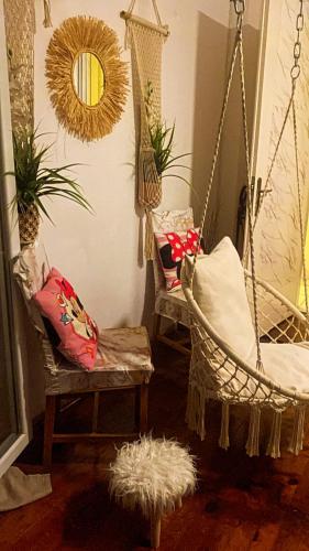 a room with two swinging chairs and a mirror at Queen Suites Family Friendly 60m2 in Thessaloniki