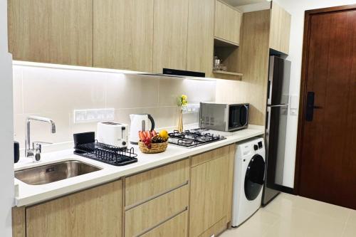 a kitchen with a sink and a stove top oven at YAKA Trizen Luxury Apartments - 53rd and 51st Floor with Stunning Views in Colombo