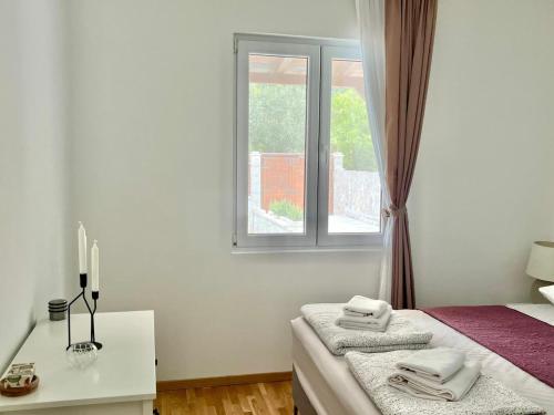 a white room with a bed and a window at Villa Bella Vita in Tivat