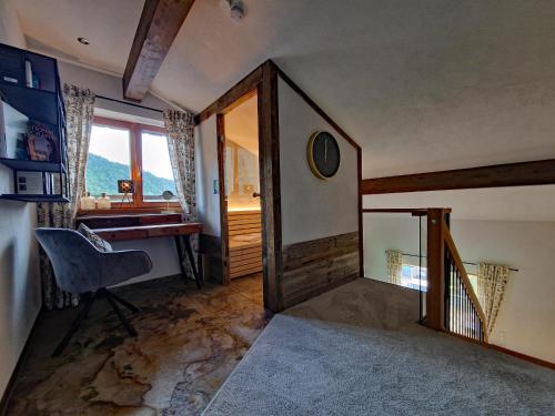 a room with a desk and a chair and a window at Alpenchalet Vils Tirol in Vils