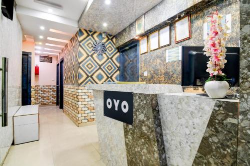 a lobby with aiya sign on a counter at Hotel O Sana in Calcutta Bara Bazar