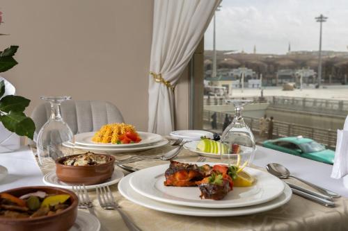 a table with plates of food on top of it at Emaar Elite Al Madina Hotel in Al Madinah
