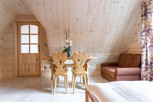 a room with a table and two chairs and a couch at Gościniec u Bobaków in Ząb