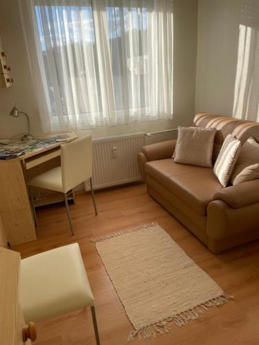 a living room with a couch and a table at Encsi apartman in Salgótarján