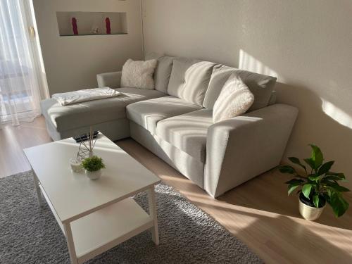 a living room with a couch and a table at Encsi apartman in Salgótarján
