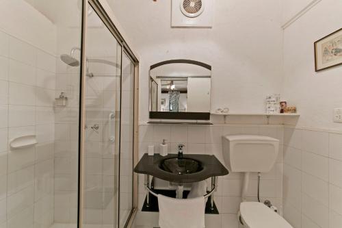 a bathroom with a sink and a toilet and a shower at Hillside Country Retreat in York