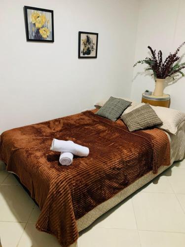 a bed with two rolls of towels on it at habitacion en sabaneta in Sabaneta