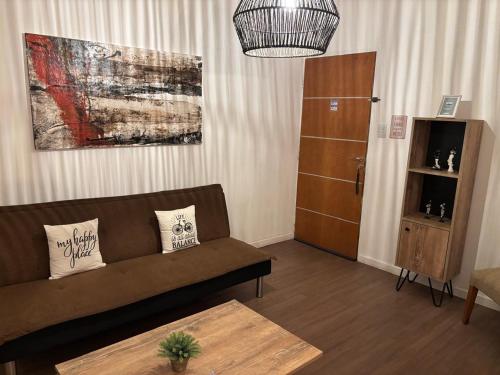 a living room with a couch and a cabinet at Depto 23 en Barrio Villa Belgrano excelente ubicación in Cordoba