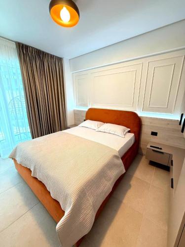 a bedroom with a large bed and a desk at Zyra Blue Heart Pool & Spa in Năvodari