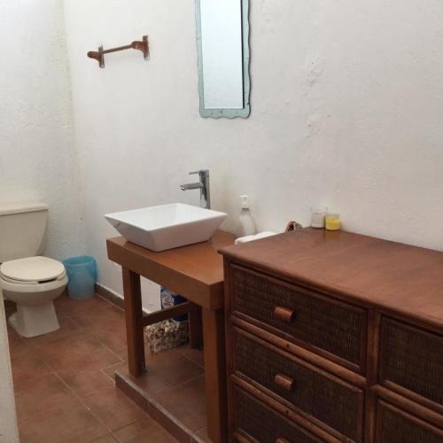 a bathroom with a sink and a toilet at House by the beach Casa Murmullos in Isla Mujeres