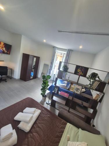 a living room with a large bed and a table at La Casa Dei Principi - B in Genazzano