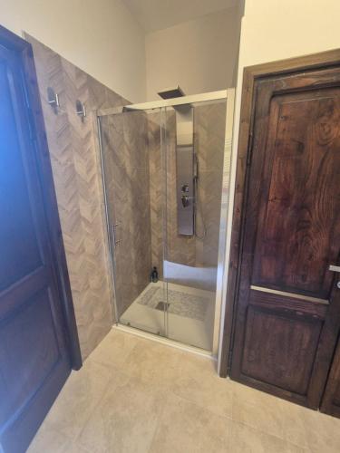 a bathroom with a shower with a glass door at La Casa Dei Principi - B in Genazzano