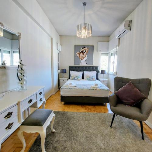 a bedroom with a bed and a chair at OLIVA 50 - 4 Bedrooms and Office - 3 Bathrooms - Near Lisbon Expo & Airport in Lisbon