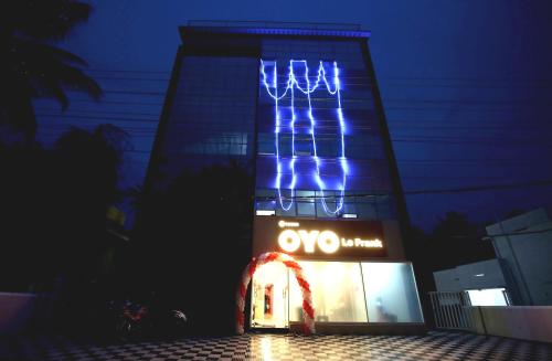 a building with blue lights on top of it at Super Hotel O Technopark Formerly Le Frank in Trivandrum