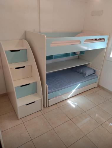 a small bedroom with a bunk bed with drawers at شقة عائلية in Nador