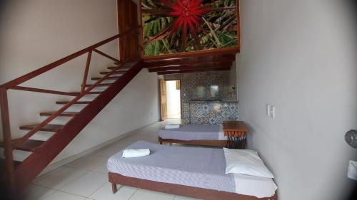 a bedroom with a staircase and a bed and a stair case at Pousada Raio de Sol in Lençóis