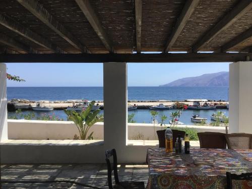 a dining room with a view of the ocean at Molos ONE in Skiros