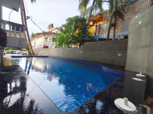 a swimming pool with a toilet next to a building at Harsh angel holiday homes in Calangute