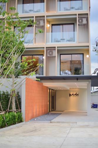 an exterior view of a building with a mak sign on it at PAAK Hotel Suvarnabhumi in Lat Krabang