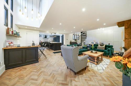 a living room with a couch and a table at School Cottage conversion in Grove Park