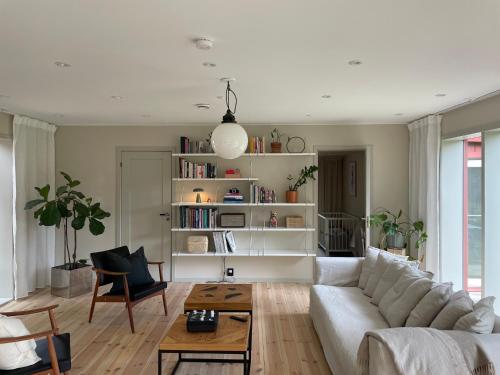a living room with a white couch and a table at The Little Red in Västerhaninge