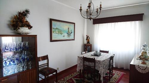 a dining room with a table and a chandelier at Casa Quinta da Adega do Chão - Vale do Douro in Lamego