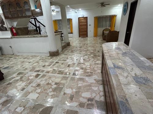 a living room with a stone floor and a table at G Apartment - Standard Room in Binicuil