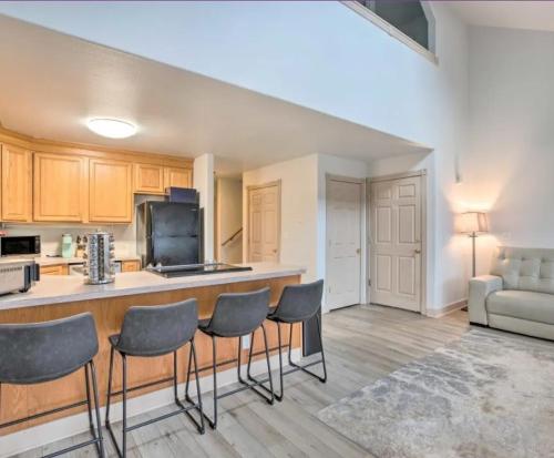 a kitchen with a bar with chairs and a couch at Coastal Adventures, Lake, Ocean, Casinos, Hiking in Neotsu