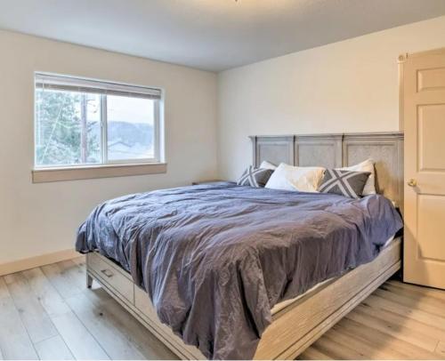 a bedroom with a large bed with a window at Coastal Adventures, Lake, Ocean, Casinos, Hiking in Neotsu