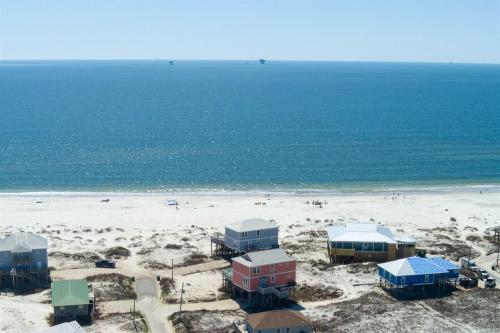 a beach with houses and people on the beach at Wave Loudest, Private Pool, Beach in Dauphin Island