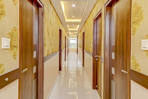 a corridor of a hospital with doors and a long hallway at Capital O Champion Lotus Near Mantri Square Mall in Bengaluru