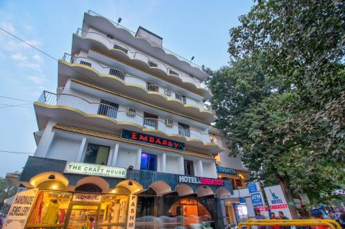a tall building with a store in front of it at Hotel O Embassy in Bodh Gaya