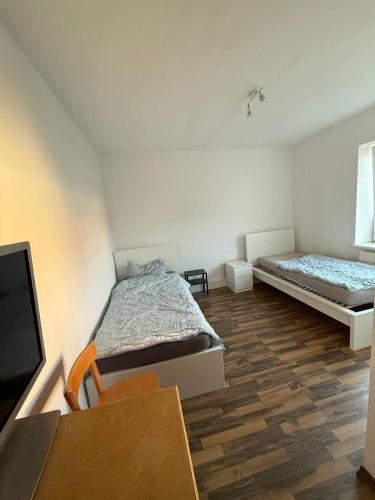 a bedroom with a bed and a flat screen tv at Ferien- und Monteurwohnungen Nähe Leipzig & A72 in Böhlen