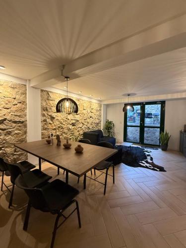 a living room with a wooden table and chairs at Alma House in Monguí