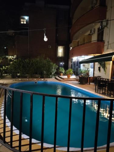 a large swimming pool in a building at night at Sani Apart Hotel in Tbilisi City