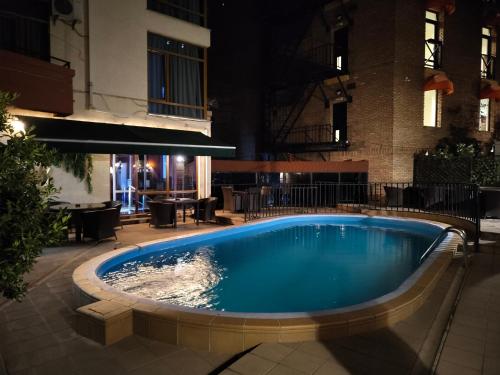 a swimming pool in the middle of a building at Sani Apart Hotel in Tbilisi City
