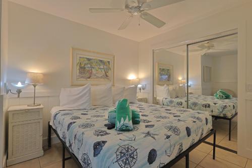 a bedroom with two beds with a stuffed animal on the bed at Siesta Key Island Rentals in Siesta Key