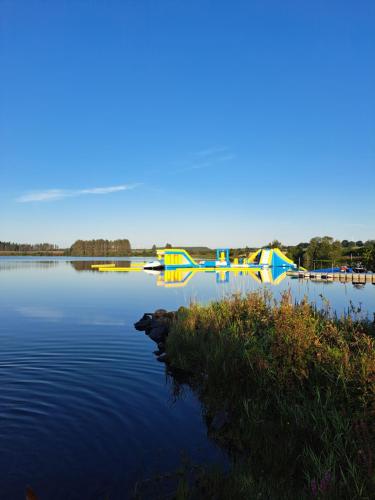 a group of boats sitting on a lake at Three lochs holiday park Loch view 123 in Balminnoch