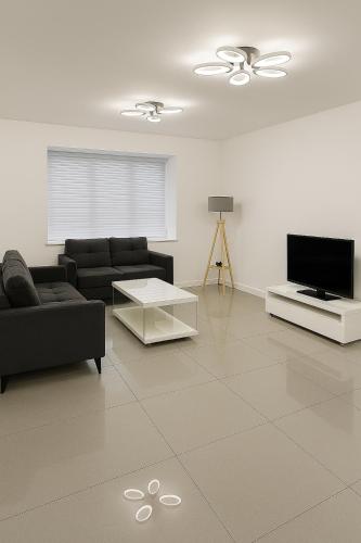a living room with a couch and a tv at Harry Potter Stay with Watford & London Links - Family house in Abbots Langley
